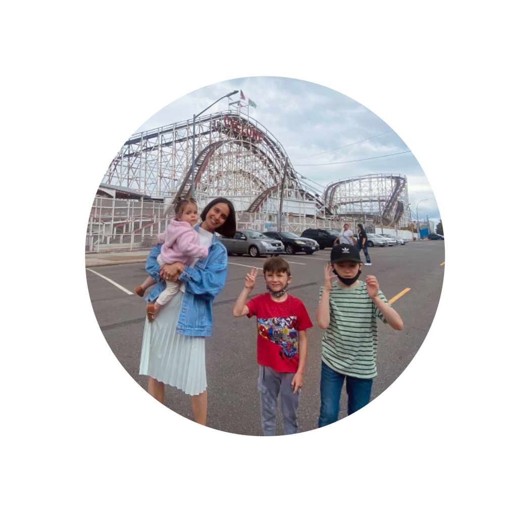 A mom and children outside of a theme park