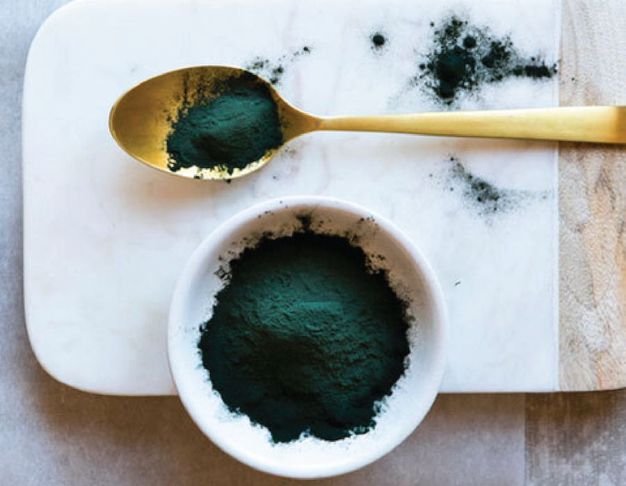 Powdered Chlorella in a bowl and on a spoon