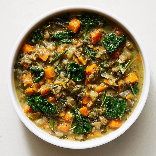 Lentil and Kale Soup in a white bowl on a white background