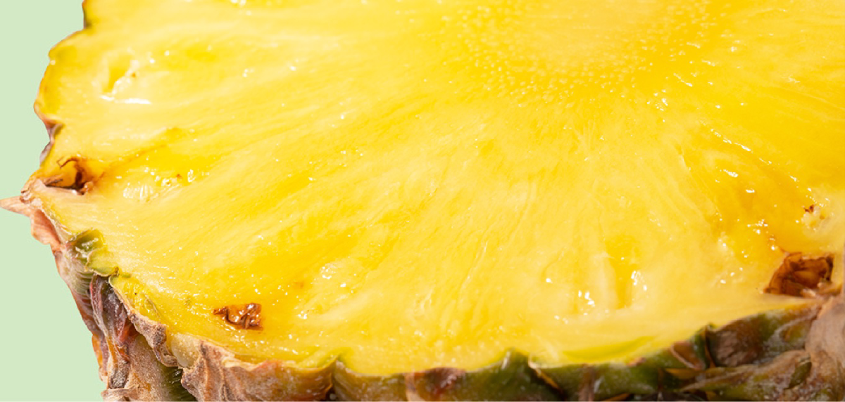 A close-up of a pineapple that has been cut in half