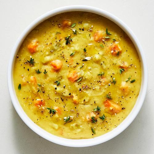 Red Lentil Dal Soup in a white bowl on a white background
