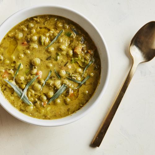 Green Split Pea Soup in a white bowl with a gold spoon